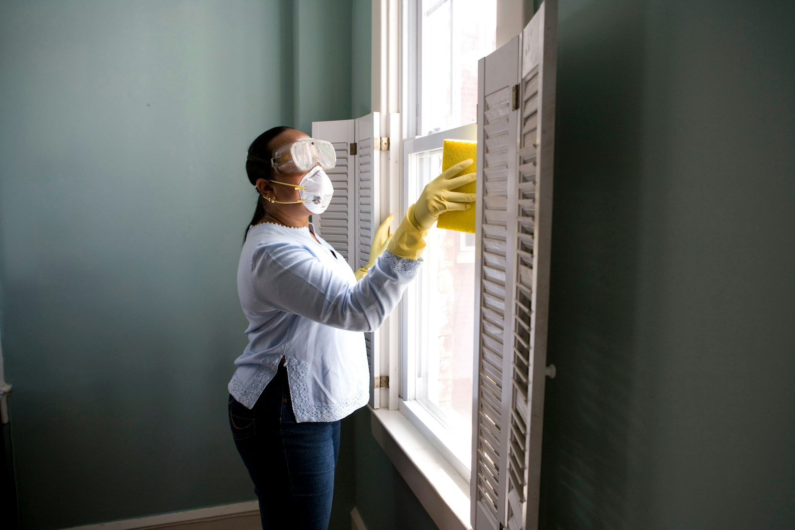 Technician handling cleaning equipment in a bright interior
